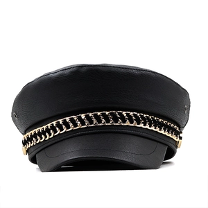 Classic black faux leather baker boy hat with a decorative gold metal chain accent