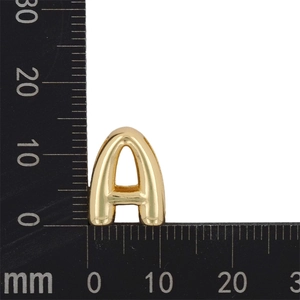Macro shot of gold letter A charm showing precise 18mm size measurements on a ruler