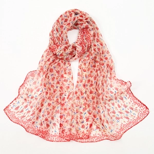 Lightweight georgette silk scarf with red floral pattern draped against a white background