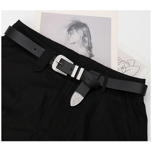 Detail of Y2K black leather belt with silver rhinestone buckle and tip decoration