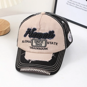 Detail of vintage baseball cap featuring Hawaii embroidery and distressed frayed edges