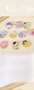 Detail showing various colorful acrylic cat brooches with Chinese greeting text charms