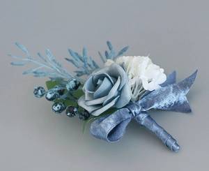 Detail of dusty blue and white silk rose boutonniere with ribbon-wrapped stem for weddings
