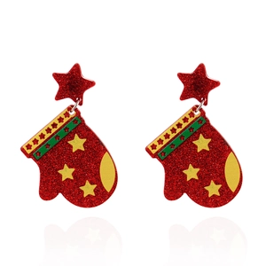 Detail of festive Christmas acrylic earrings with sparkling red glitter and star accents
