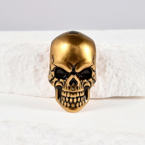 Detailed view of vintage gold skull accessory with antique plating and metal texture