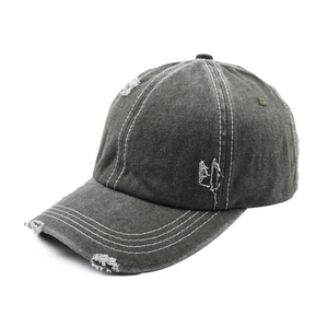 Close-up of distressed cotton canvas baseball cap with vintage worn-out details and embroidery