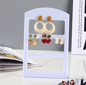Three-tier white acrylic jewelry display stand with holes for earrings and studs