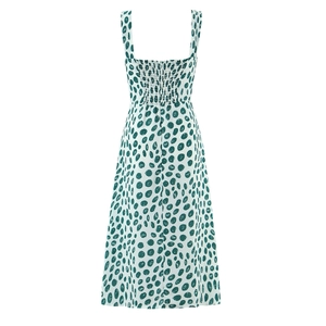 Green polka dot sleeveless midi dress with smocked back and side slit on white background