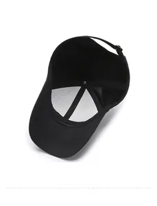 Detail view of black cotton baseball cap interior with white support lining and metal buckle