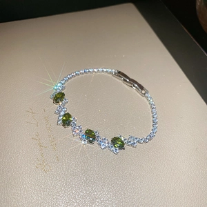 Detailed macro view of vintage emerald flower link bracelet with silver plating and crystals