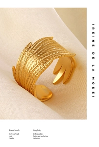 Detail of 18K gold-plated feather ring with intricate wheat ear relief and open design