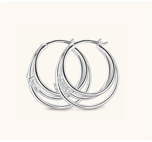 Detailed macro view of silver multi-layer hoop earrings with sparkling moissanite accents