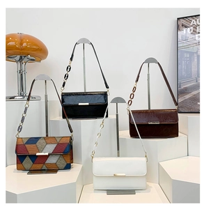 Detailed view of four textured leather shoulder bags in black, brown, white and multicolor