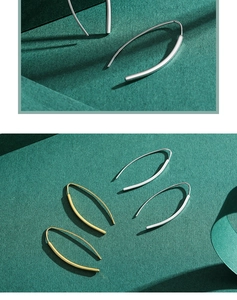 Detail of minimalist S925 sterling silver curved hook earrings in gold and silver finish