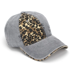 Detail of vintage washed baseball cap with leopard patch and distressed black stitching