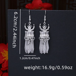 Detail view of ethnic silver drop earrings with leaf tassels and dimensions 6.2cm x 1.2cm