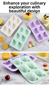 Macro detail of 6-cavity silicone bear cake mold in white, mint green, and purple