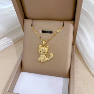 Close-up of a gold cat pendant with sparkling rhinestones in a luxury gift box
