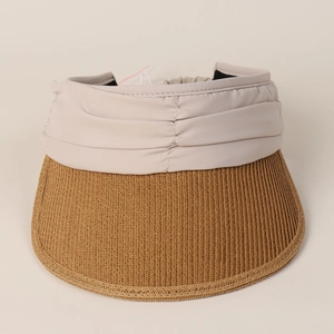 Detail of women's visor hat showing pleated fabric headband and woven straw brim texture
