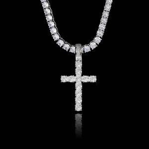 Detailed view of hip hop cross pendant with clear cubic zirconia on silver tennis chain