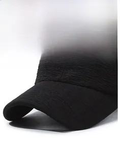 Macro detail of textured black baseball cap fabric showing the structured brim design