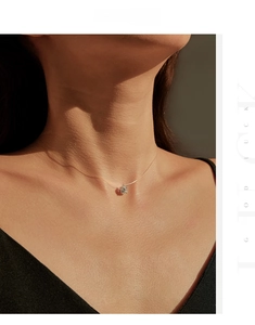 Macro detail of 1 carat moissanite pendant on minimalist invisible fishing line necklace