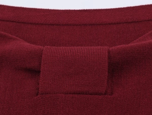 Close-up of wine red knit top showing detailed ribbed cuffs and high-quality flat stitch texture