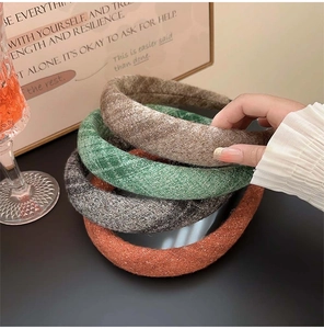 Close-up of thick solid color wool textured headbands in brown, green, gray and orange