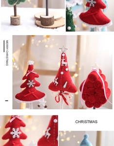 Detail of handmade wool felt Christmas tree with wooden base and festive deer ornaments