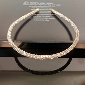 Detailed view of luxury thin headband with shimmering rhinestones and gold metal tips