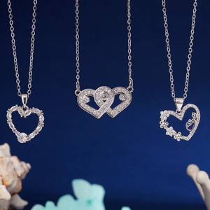 Three elegant heart-shaped zircon necklaces in silver titanium steel on blue background