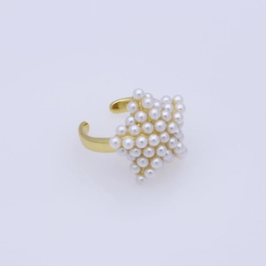 Detail view of a gold-finish open ring featuring a delicate rhombus pearl cluster