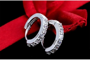 Macro view of S925 sterling silver earring featuring single row of clear cubic zirconia
