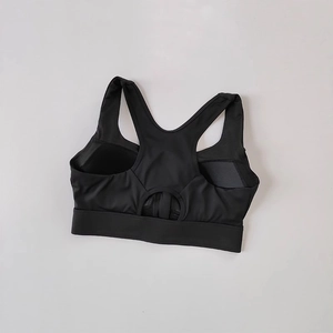 Detail of black racerback sports bra with breathable hollow cutout and high-stretch fabric