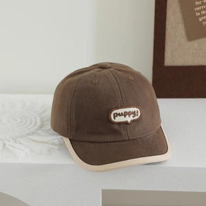 Close-up of brown canvas kids baseball cap featuring puppy embroidery and beige trim