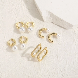 Detailed close-up of bohemian 14K gold plated pearl earrings with zircon embellishments
