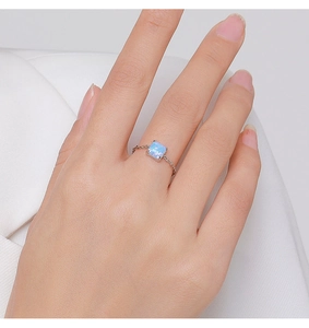 Close-up of a 925 silver adjustable ring featuring a square light blue opal stone