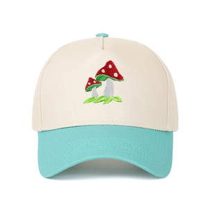 Detailed close-up of mushroom embroidery on a two-tone canvas trucker hat with contrast brim