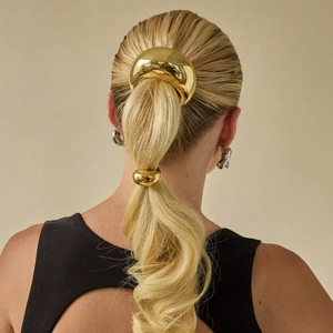 Elegant gold metal U-shaped hair tie and ponytail cuff set on a female model with blonde hair