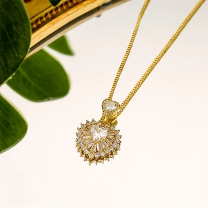 Detailed macro view of heart-shaped zircon pendant with gold finish box chain necklace