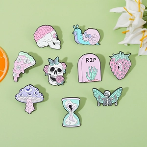 Detailed close-up of macaron color enamel pins set featuring skull and strawberry designs