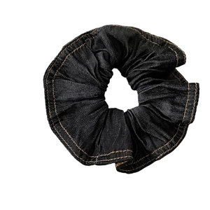 Elegant black denim scrunchie with yellow stitching for women's hairstyle fashion