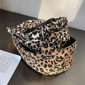 Classic American leopard print newsboy cap with metal buckle detail and denim texture