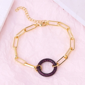 Detail of gold-plated link bracelet with a deep purple pave-set crystal round pendant