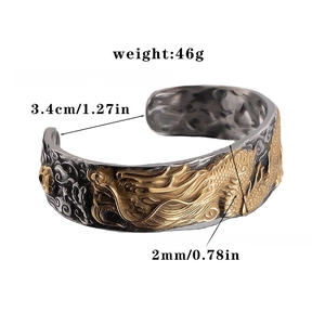 Close-up of vintage dragon relief bangle in black and gold titanium steel finish