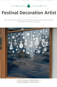 Close-up of white snowflake and bell static window decals on a winter glass frame