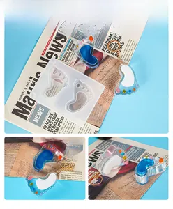 Detail view of foot-shaped silicone molds and blue resin keychains on a blue background