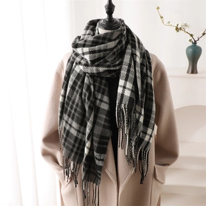 Plaid cashmere-like scarf with fringe tassels shown on a beige wool coat over gray colors