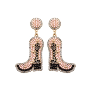 Detailed view of pink pearl cowboy boot earrings with Rowdy text and gold trim