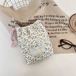 Detail of blue floral quilted cotton drawstring pouch for camera and small accessories